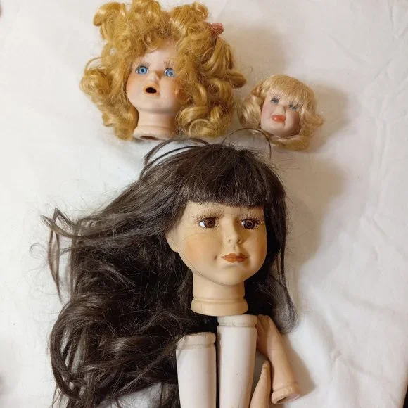Three Porcelain Doll Heads One set of Hands and Feet